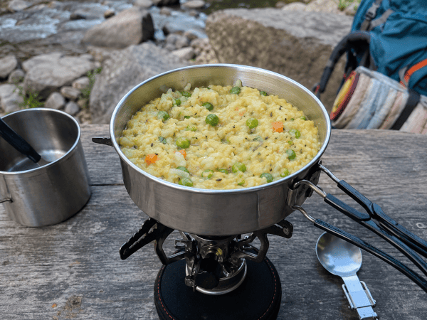 Khichdi cooking in one pot on a camping stove
