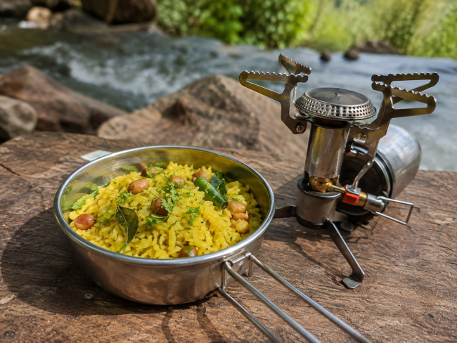 Poha served in a steel bowl at a campsite